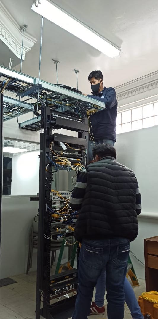 Two men installing equipment