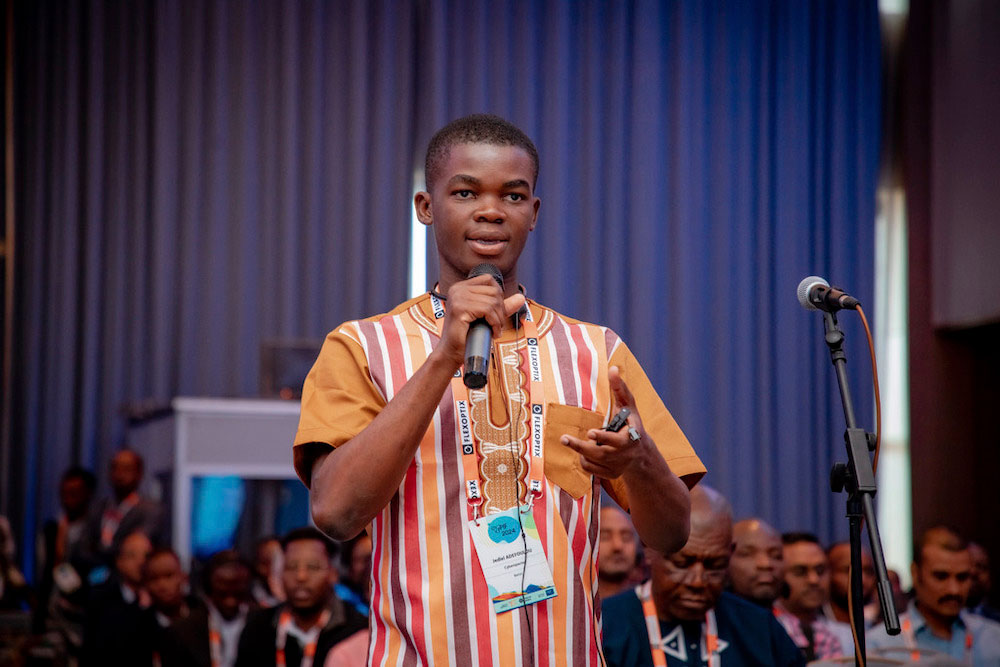 A man stands and speaks into a microphone at afpif