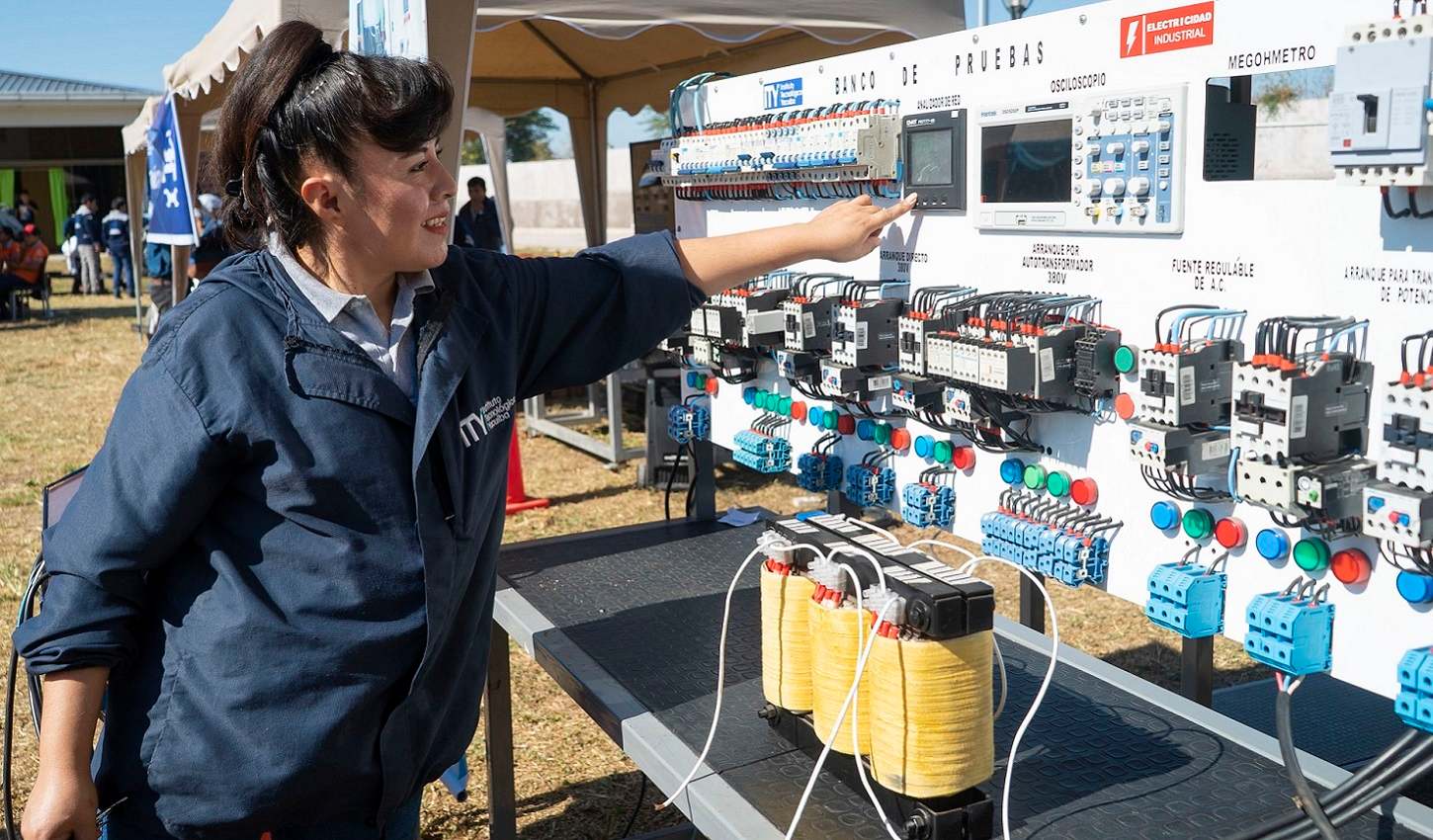 A woman pointing on an installation board